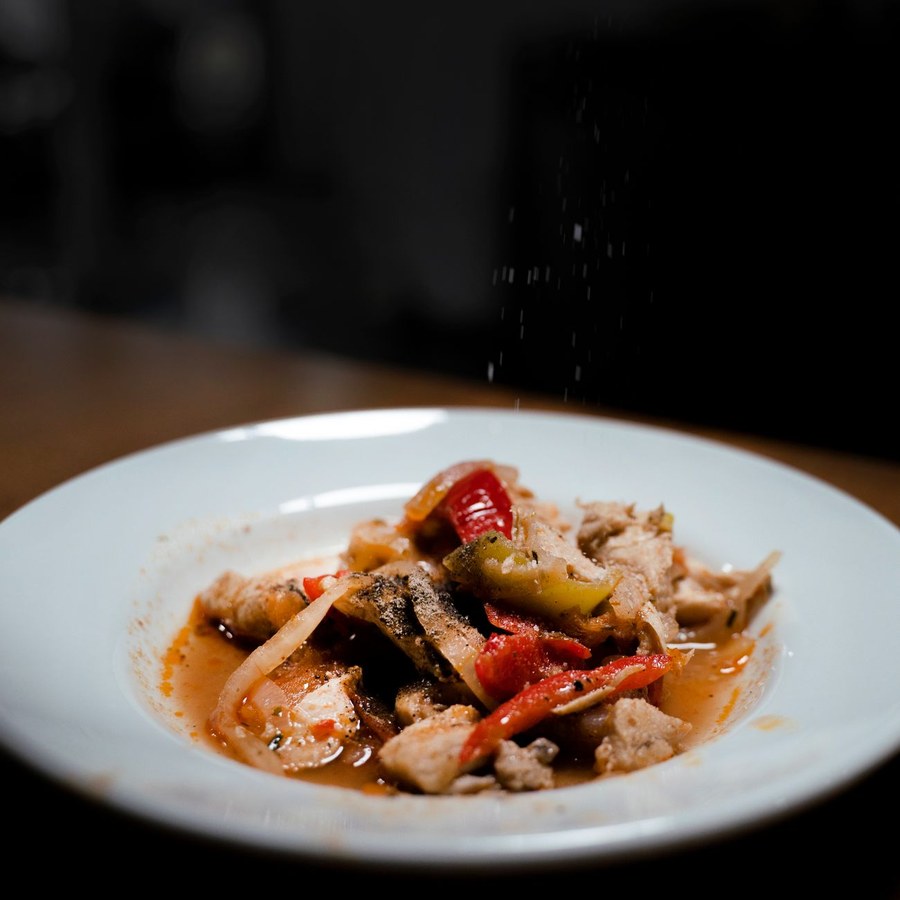 Beautifully plated dish with warm lighting in professional kitchen